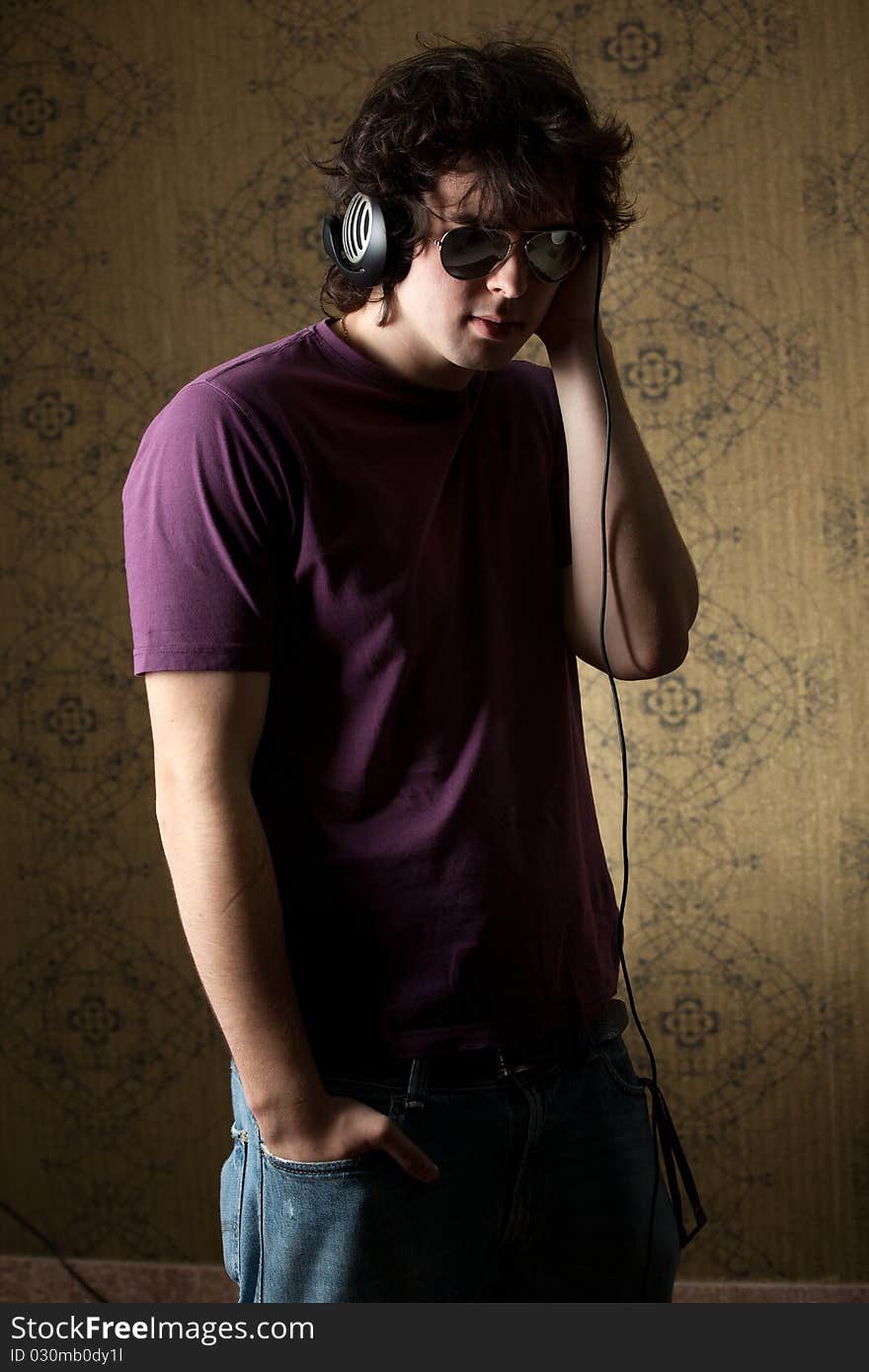 An image of young man listening to music in headphones