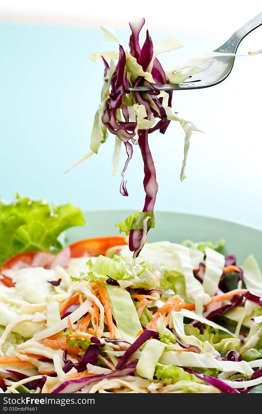 Fork and colorful mixed vegetable salad. Fork and colorful mixed vegetable salad