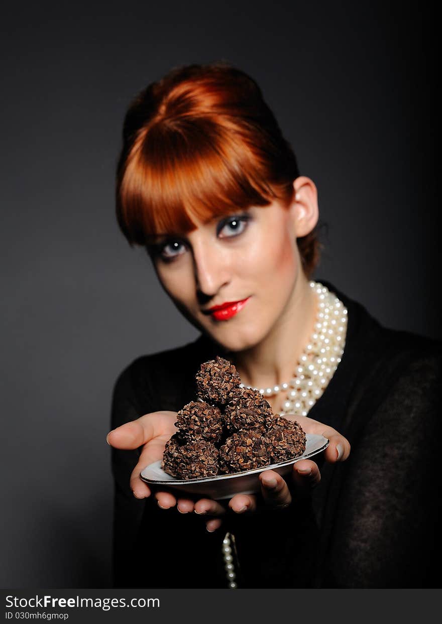 Beautiful elegant fashion woman with chocolate truffle sweets. Beautiful elegant fashion woman with chocolate truffle sweets