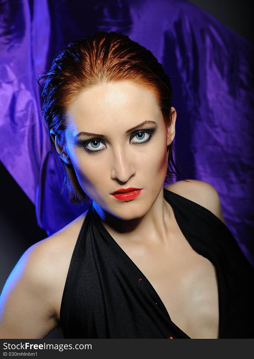 Beautiful desperate woman with perfect bright make-up with red lips and dark shadowed eyes