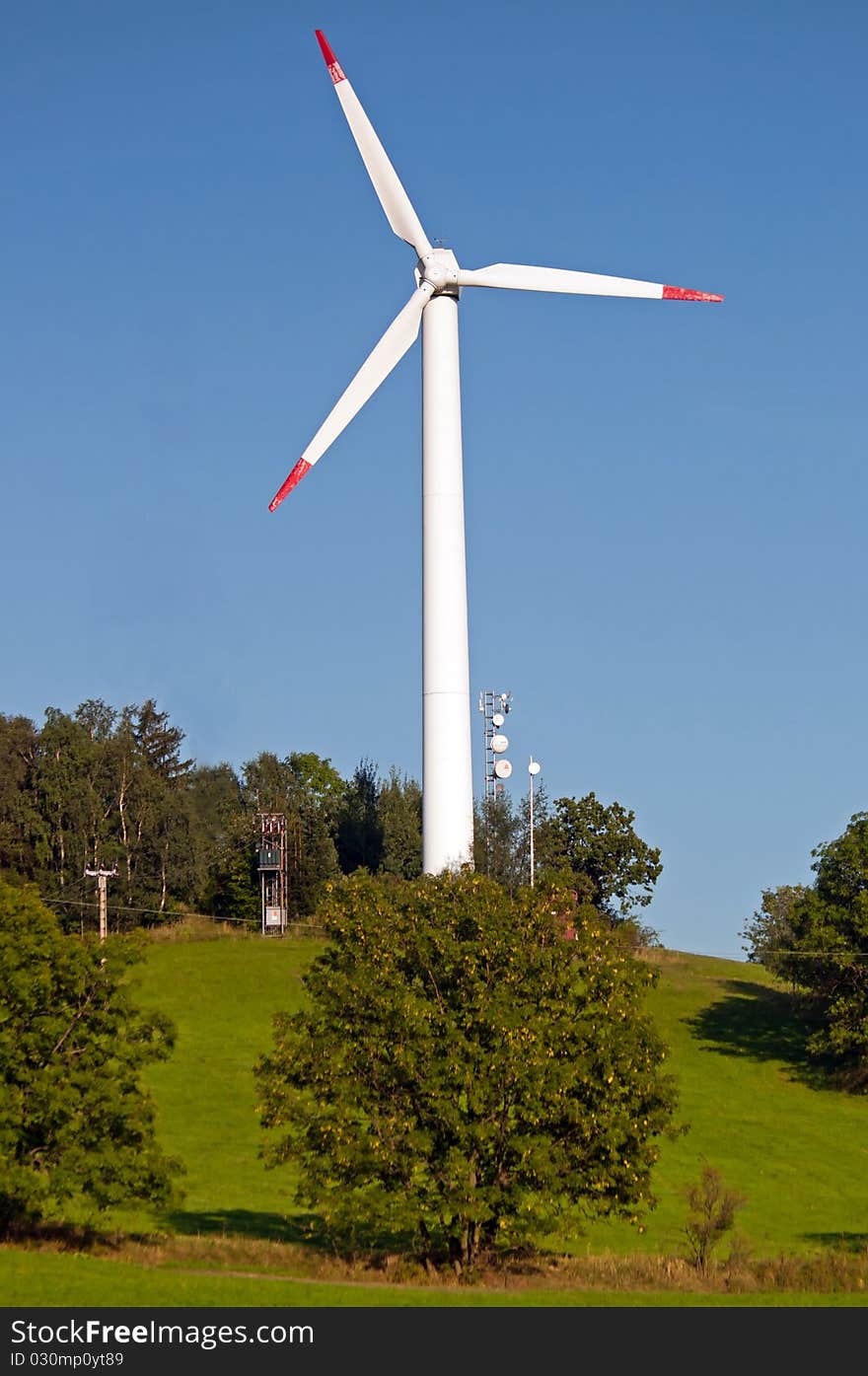 Sollar windmill on the blue background, vertical shot. Sollar windmill on the blue background, vertical shot.