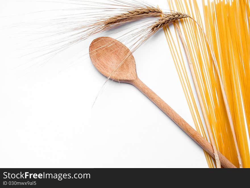 Ear of wheat, pasta and wooden spoon