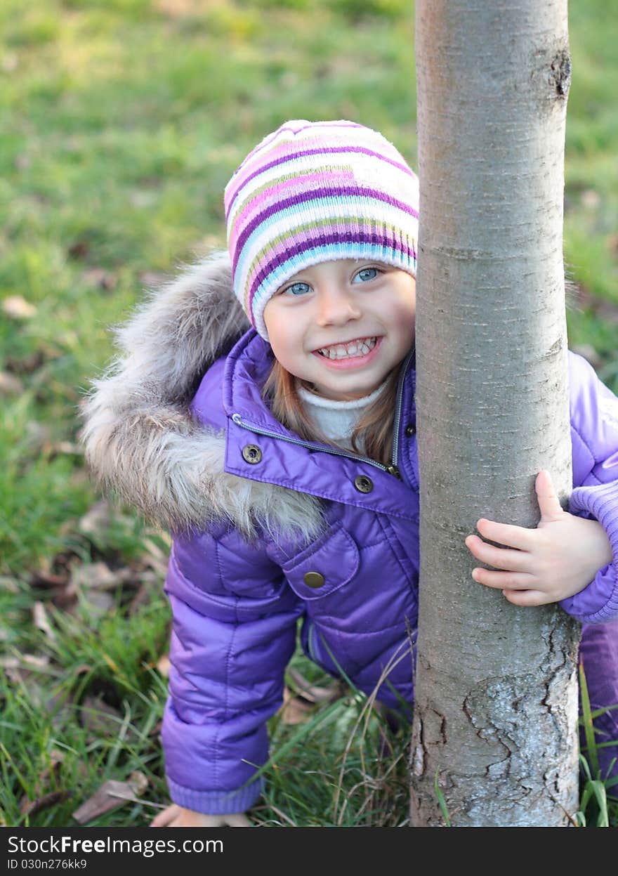 Beautiful little girl laughing outdoors