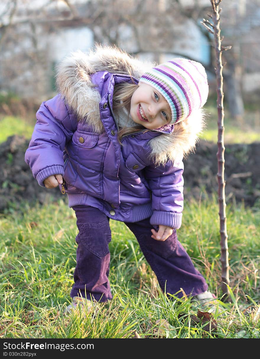 Beautiful little girl laughing outdoors