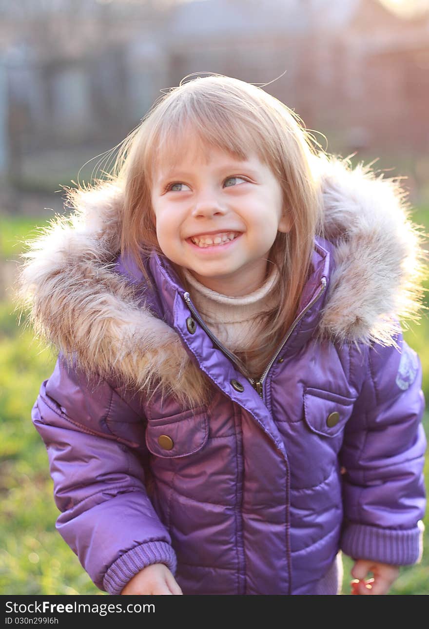 Beautiful little girl laughing outdoors