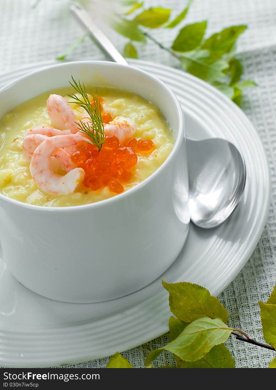 Vegetable soup with rice, shrimp and caviar for dinner