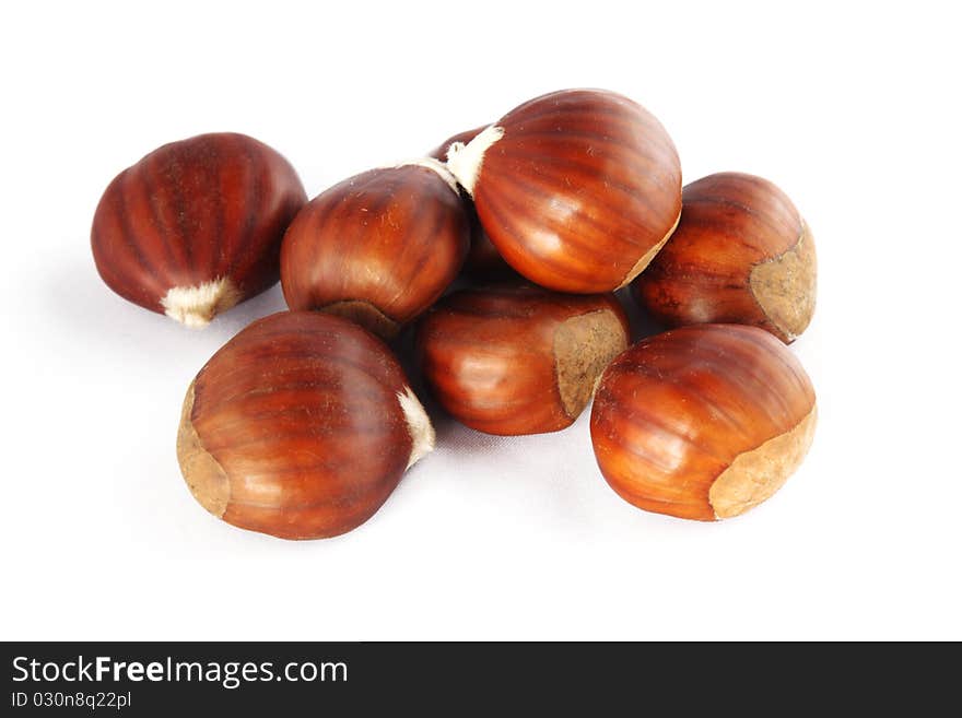 Chestnuts over a white background.