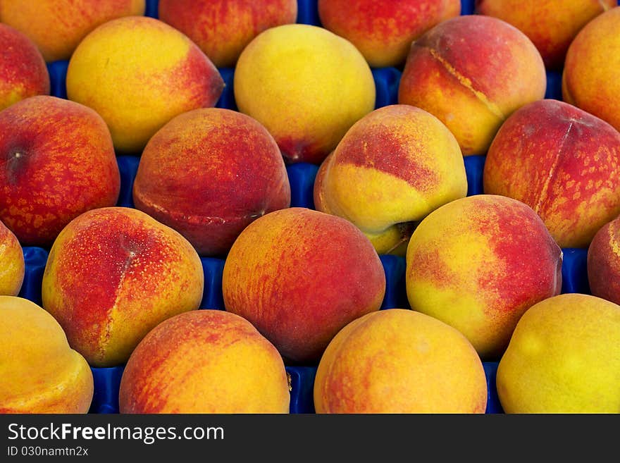 Landscape view of peaches background in the box in a market. Landscape view of peaches background in the box in a market