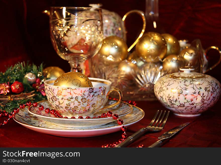 Table with gold dishes on red background. Table with gold dishes on red background