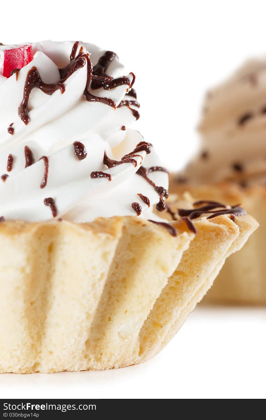 Macro view of cake with whipped cream isolated over white