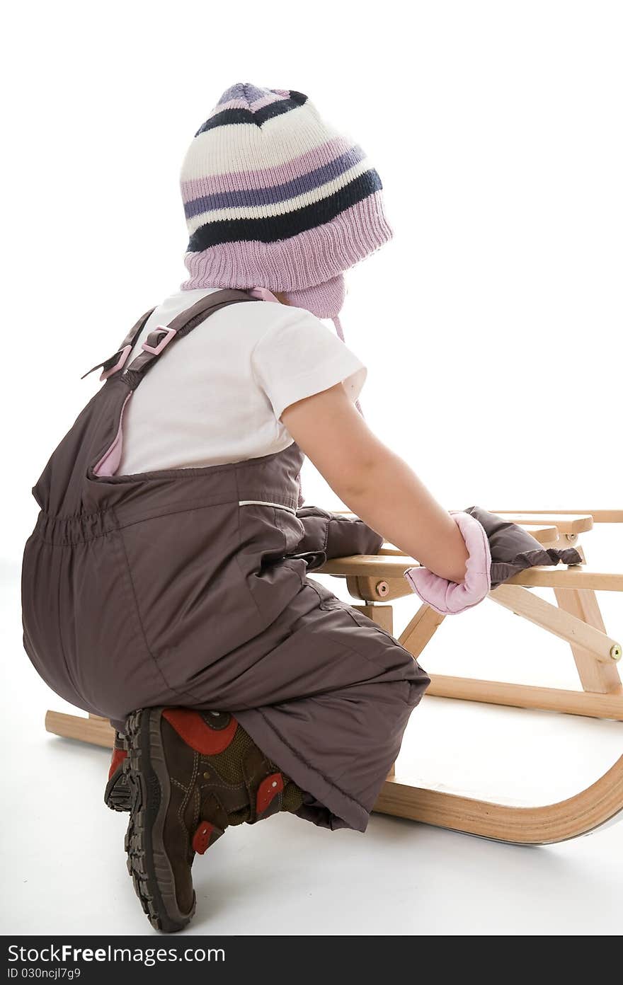 Little girl on sledge is making fun and smiling. Little girl on sledge is making fun and smiling