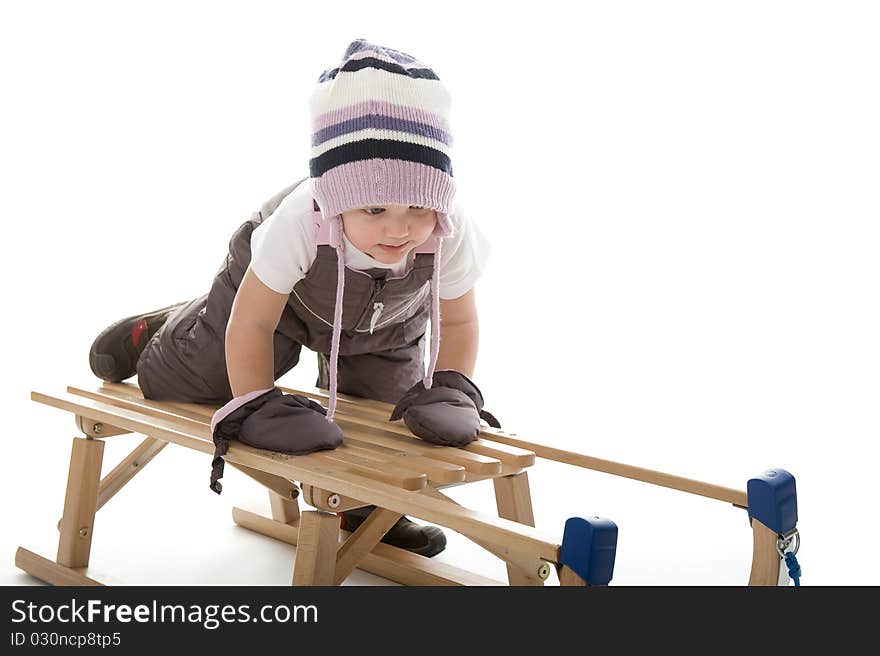 Little girl on sledge is making fun and smiling. Little girl on sledge is making fun and smiling