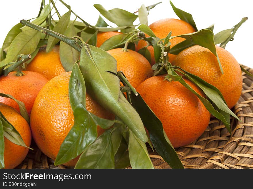 Fresh mandarines on a wicker plate