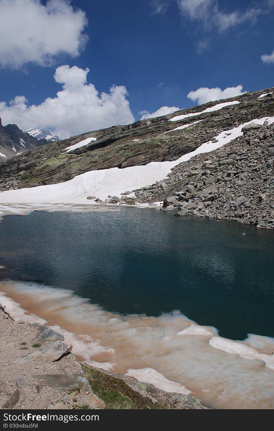 Lake and snow during the spring in Piemonte. Lake and snow during the spring in Piemonte