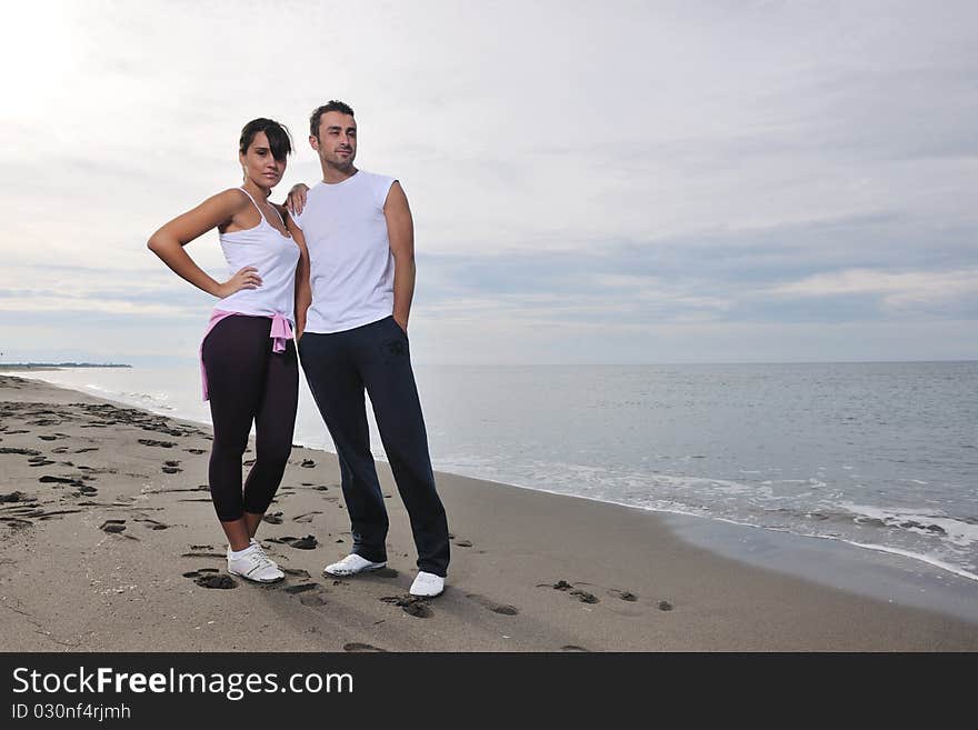 Happy young couple in white clothing have romantic recreation and fun at beautiful beach on vacations. Happy young couple in white clothing have romantic recreation and fun at beautiful beach on vacations