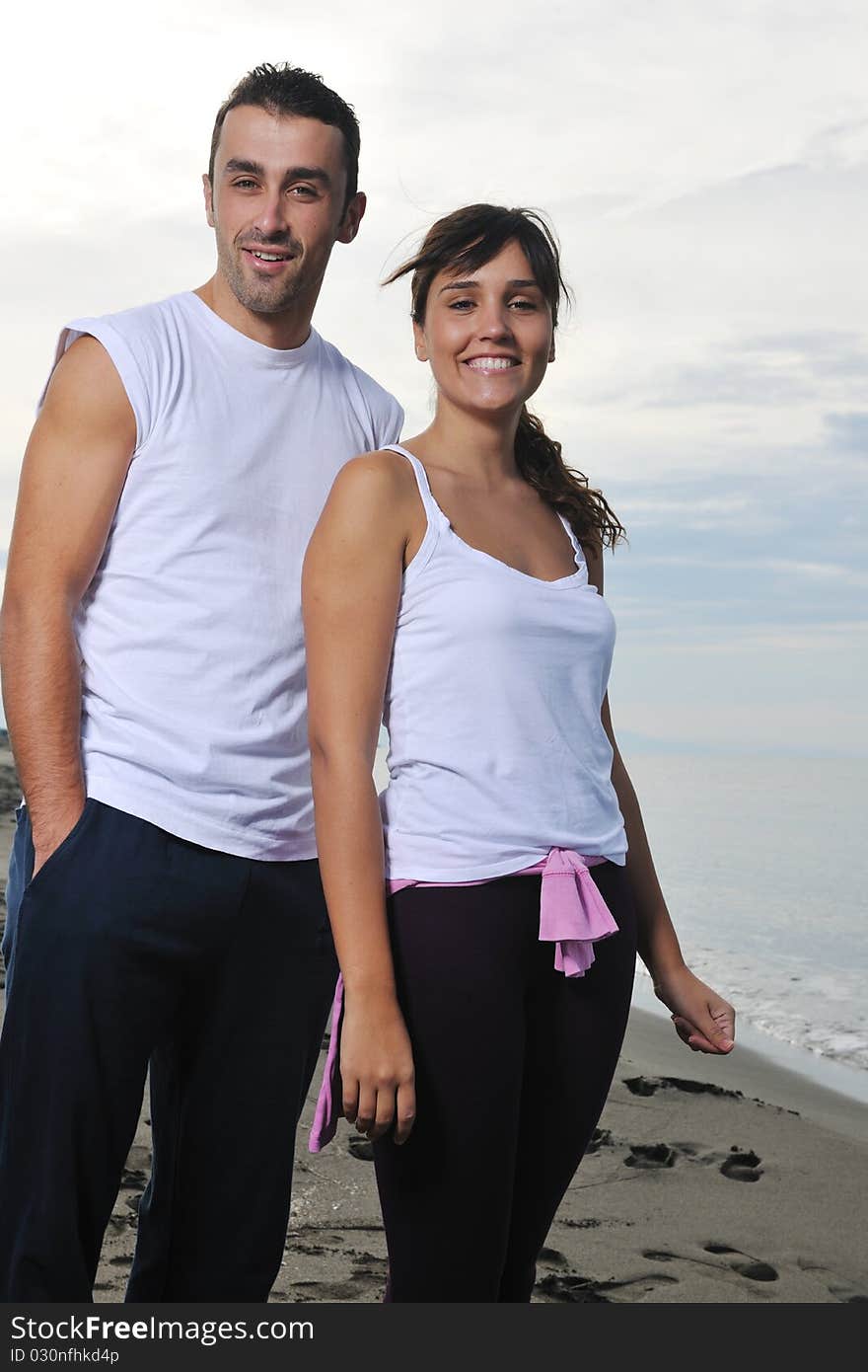 Happy young couple in white clothing have romantic recreation and fun at beautiful beach on vacations. Happy young couple in white clothing have romantic recreation and fun at beautiful beach on vacations