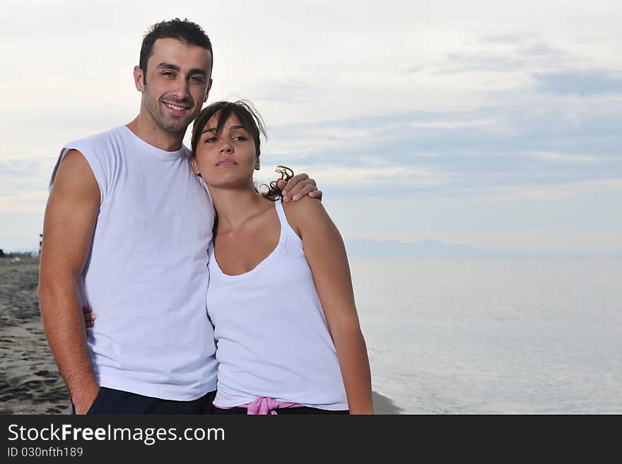 Happy Young Couple Have Fun At Beautiful Beach