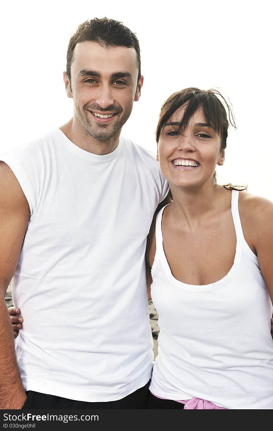 Happy Young Couple Have Fun At Beautiful Beach