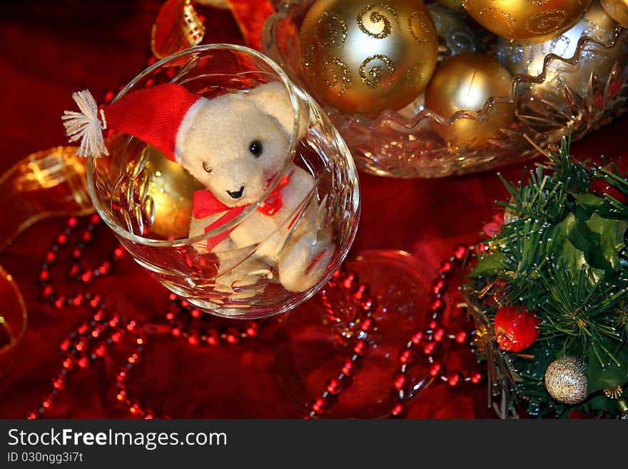 White Teddy bear, a glass of wine and Christmas decorations. White Teddy bear, a glass of wine and Christmas decorations