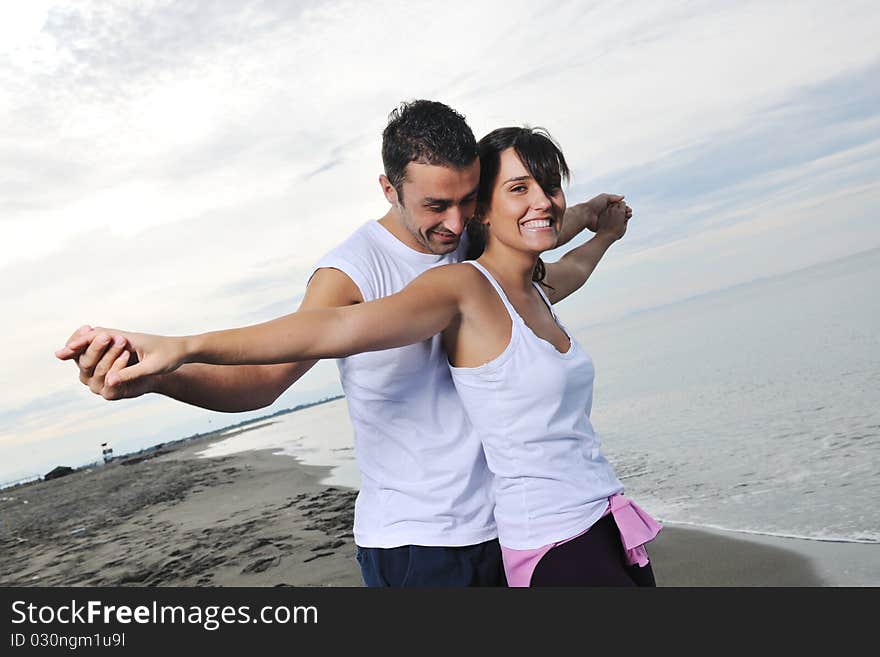 Happy young couple have fun at beautiful beach