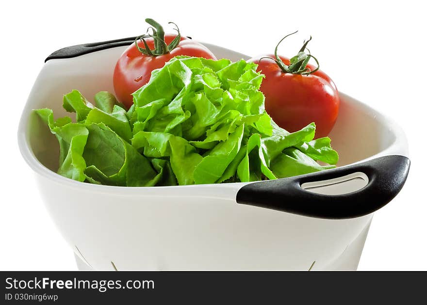 Lettuce and tomatoes in a colander