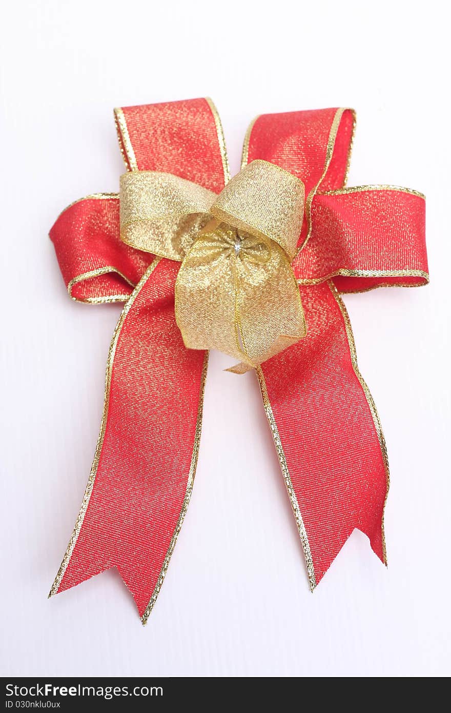 Red bow and paper on white background