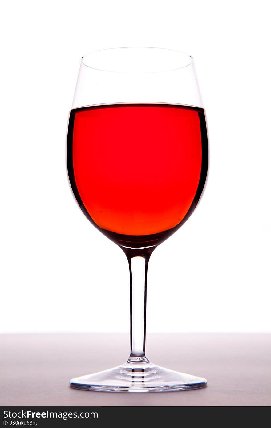 A glass of rose wine on a white background