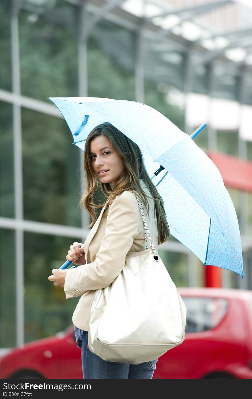 Beautiful woman holding a blue umbrella. Beautiful woman holding a blue umbrella