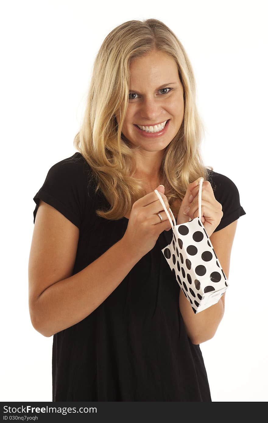 Close up portrait of young woman in black with small black and white shopping bag. Close up portrait of young woman in black with small black and white shopping bag