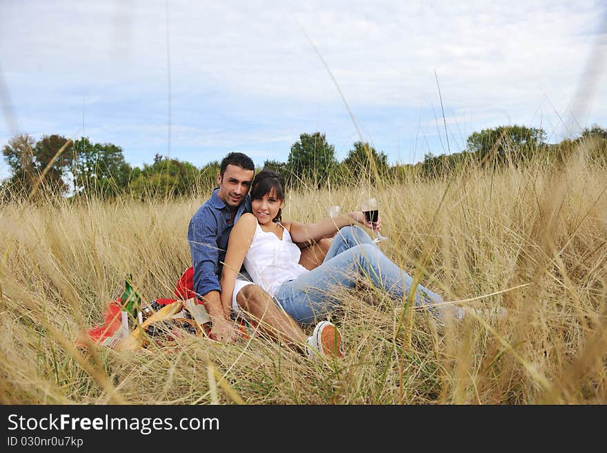 Happy young couple enjoying  picnic on the countryside in the field  and have good time. Happy young couple enjoying  picnic on the countryside in the field  and have good time