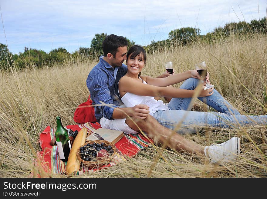 Happy young couple enjoying  picnic on the countryside in the field  and have good time. Happy young couple enjoying  picnic on the countryside in the field  and have good time