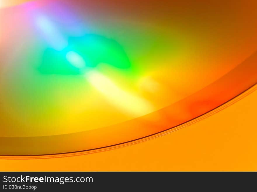 Fragment of a compact disc with a bright reflecting surface. Fragment of a compact disc with a bright reflecting surface