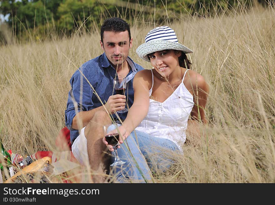 Happy young couple enjoying  picnic on the countryside in the field  and have good time. Happy young couple enjoying  picnic on the countryside in the field  and have good time