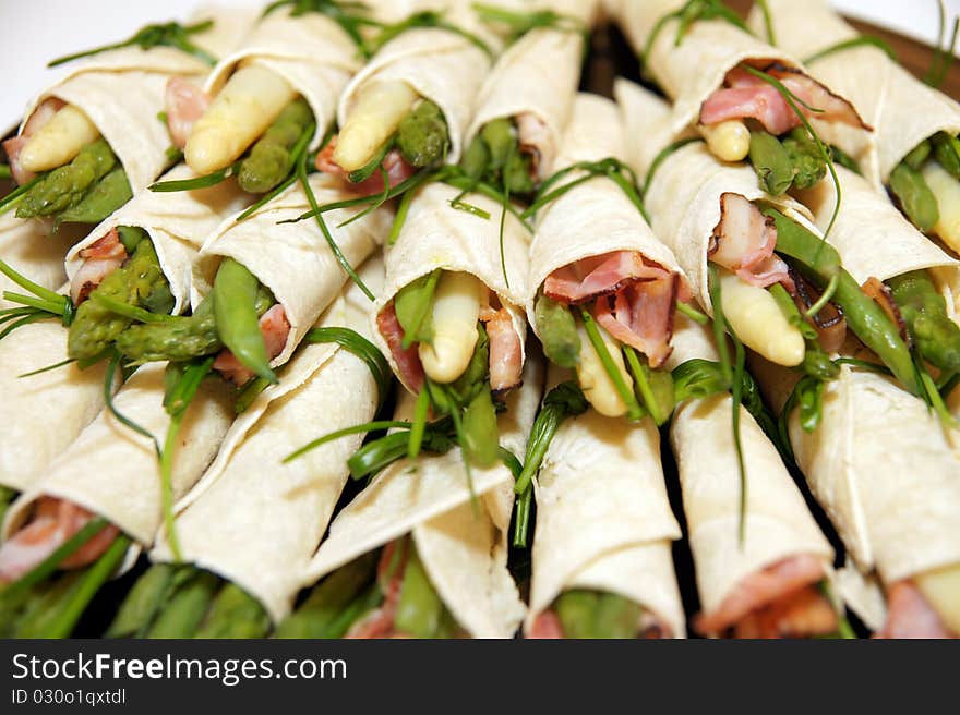 Detail on asparagus party rolls with ham. Detail on asparagus party rolls with ham