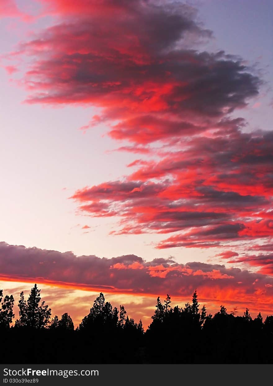 Setting sun has given the cloud formation a temporary and fleeting brilliant red coloring. Setting sun has given the cloud formation a temporary and fleeting brilliant red coloring