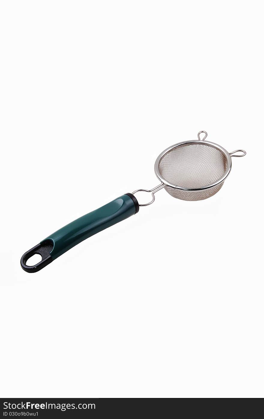 A new small sieve made from stainless steel with a green plastic handle for white background. A new small sieve made from stainless steel with a green plastic handle for white background.