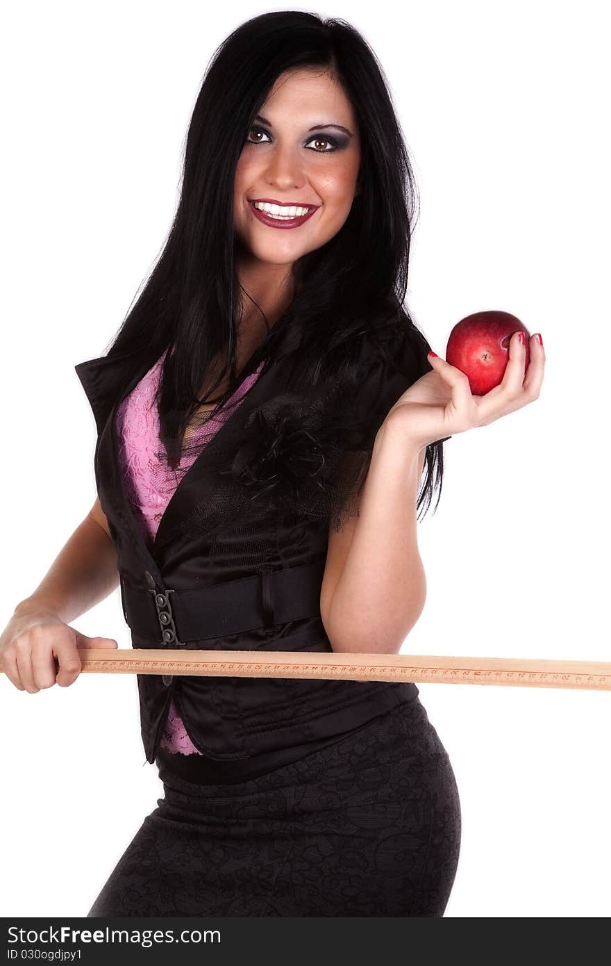 A woman is dressed like a teacher with a ruler in one hand and an apple in the other. A woman is dressed like a teacher with a ruler in one hand and an apple in the other.