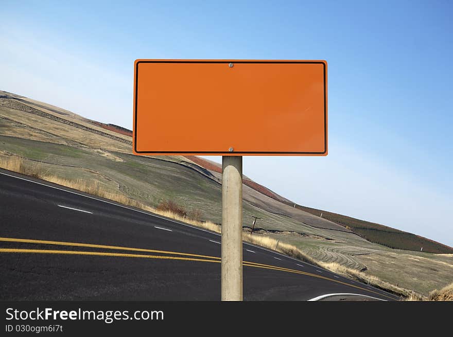 Blank orange construction sign outdoor day time asphalt highway on background