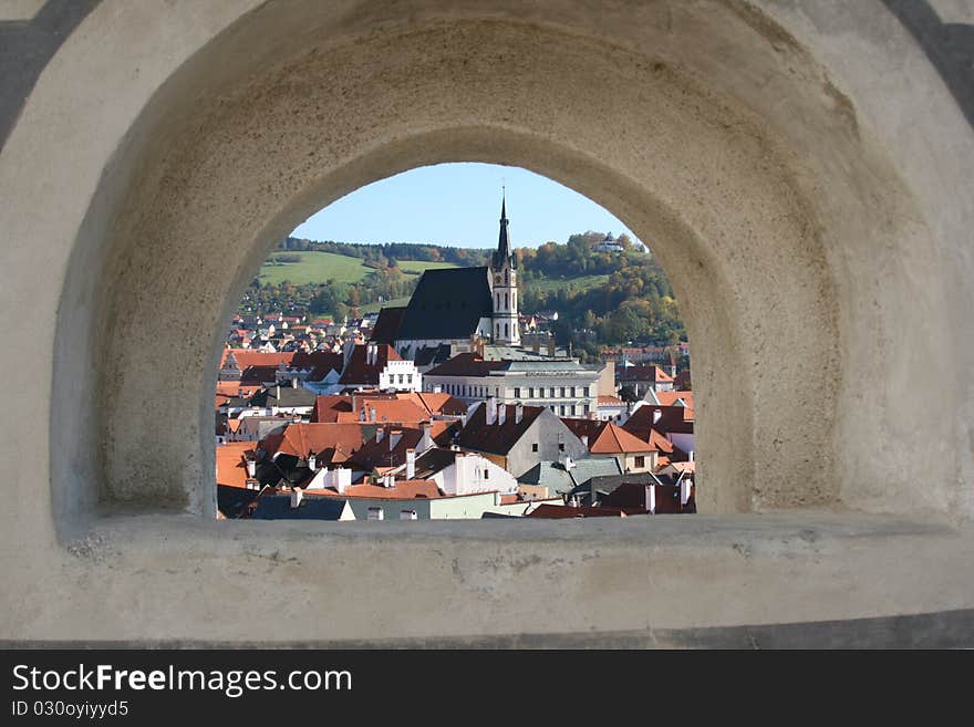 Small houses with tile roofs through an observation port. Small houses with tile roofs through an observation port