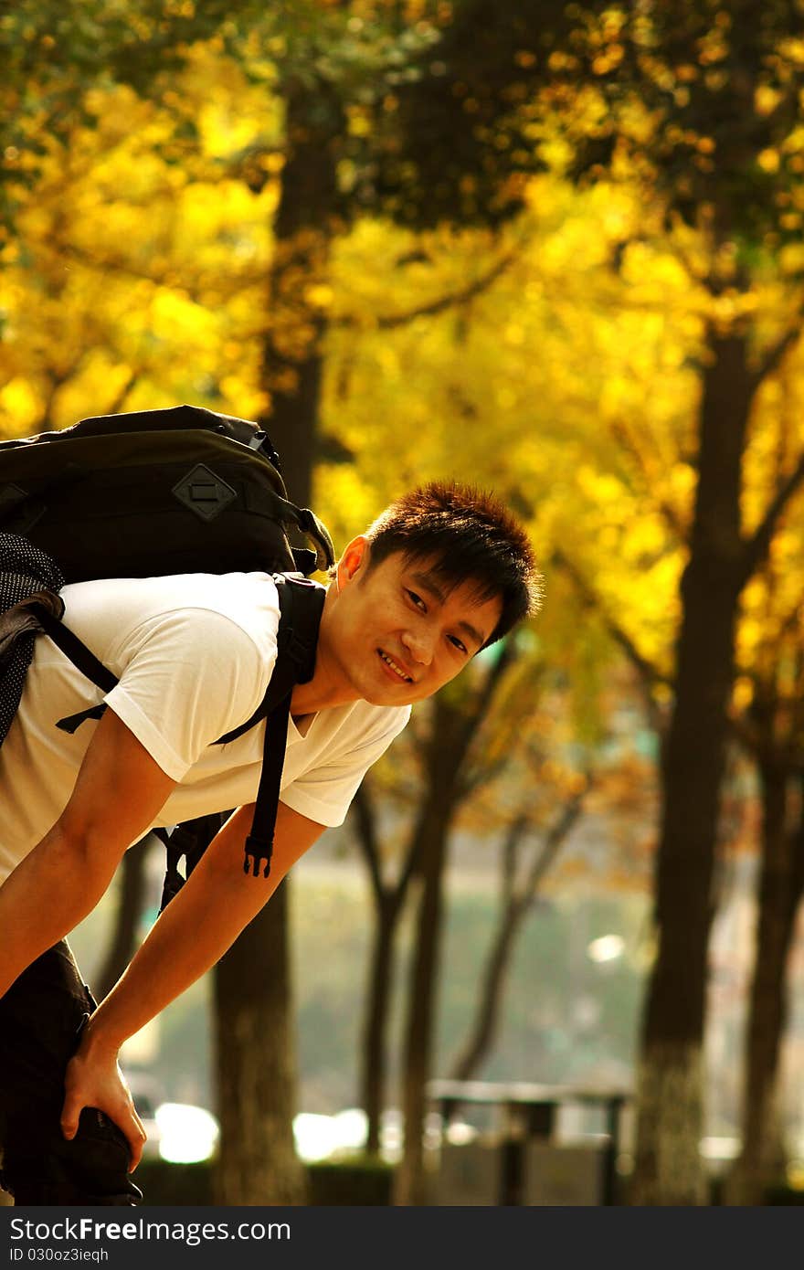 Young man in the golden autumn, a smile