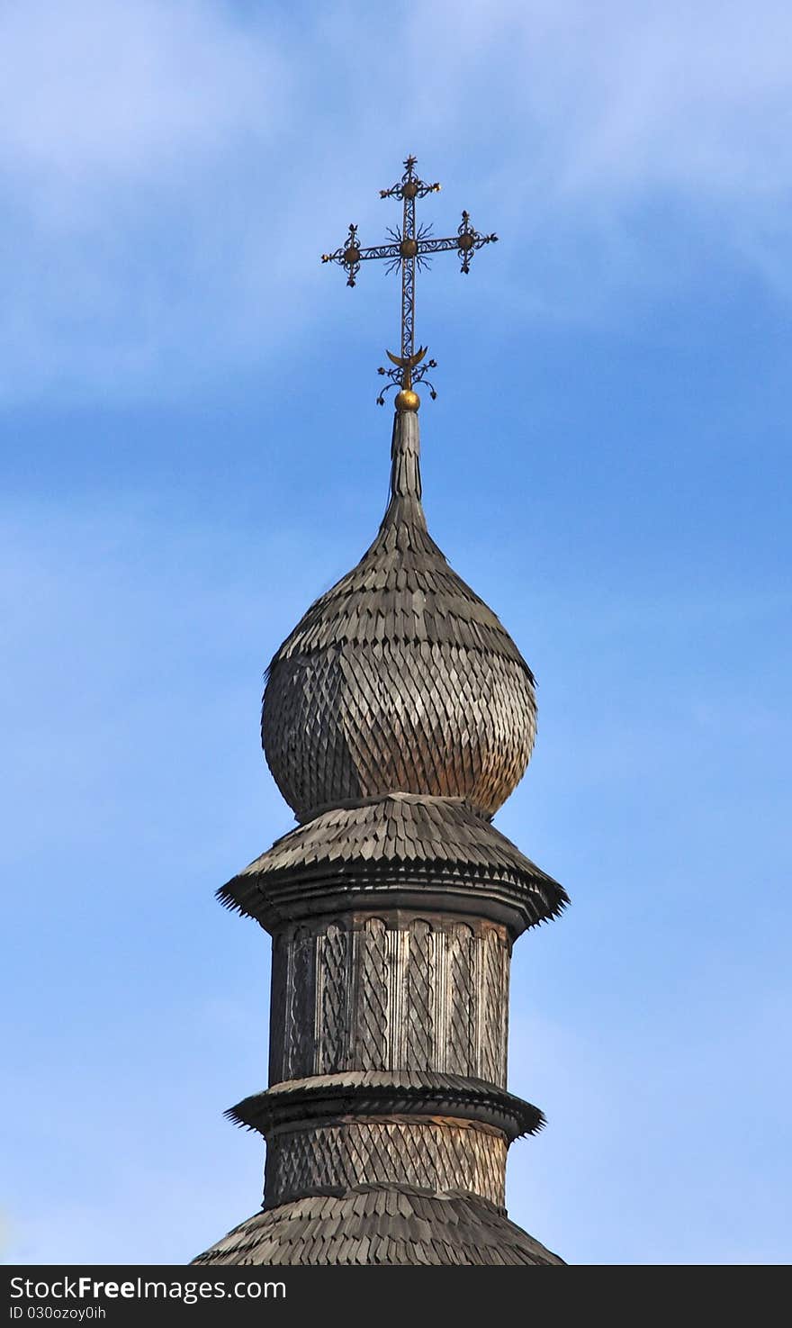 Dome of wooden church against the blue sky