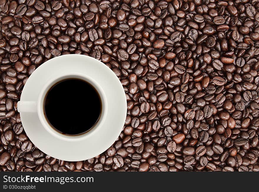 Coffee cup on coffee bean background,top view