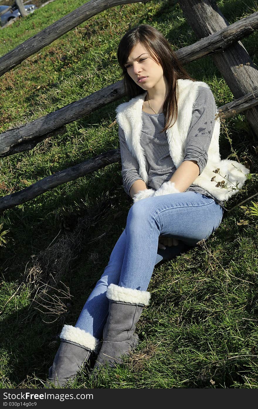 Upset brunette girl meditating outside. Upset brunette girl meditating outside