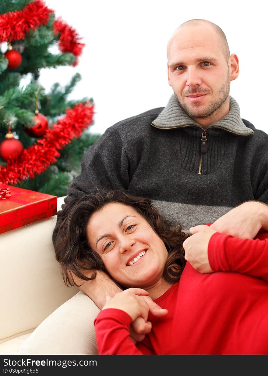 Young happy couple near a Christmas tree. Young happy couple near a Christmas tree