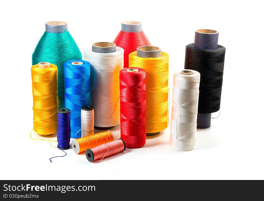 Set of color bobbins on a white background