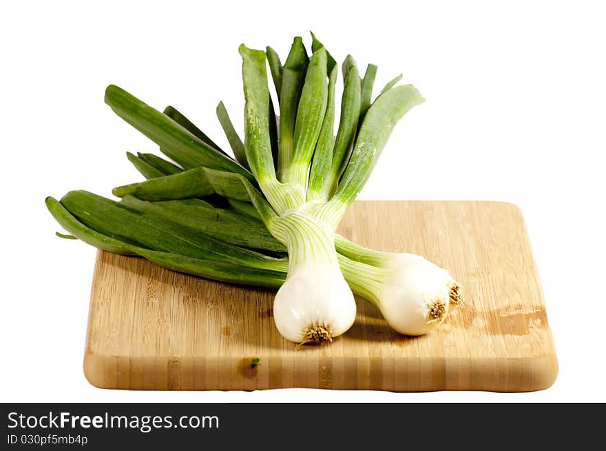 Several vegetables on a wooden cutting board. Several vegetables on a wooden cutting board