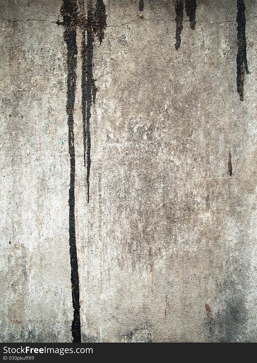 Black color drop on grunge old wall