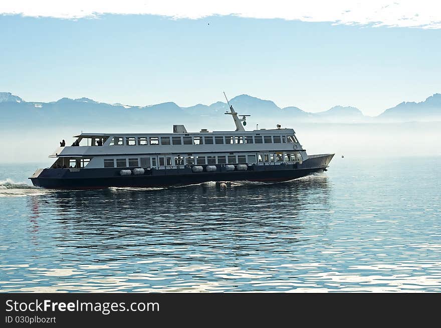 A ship cruise in a misty lake