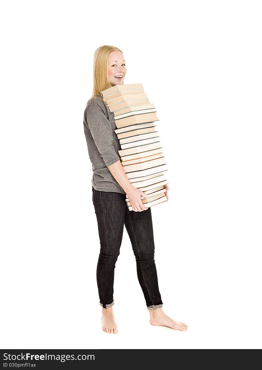 Young girl carrying a pile of books isolated on white background. Young girl carrying a pile of books isolated on white background