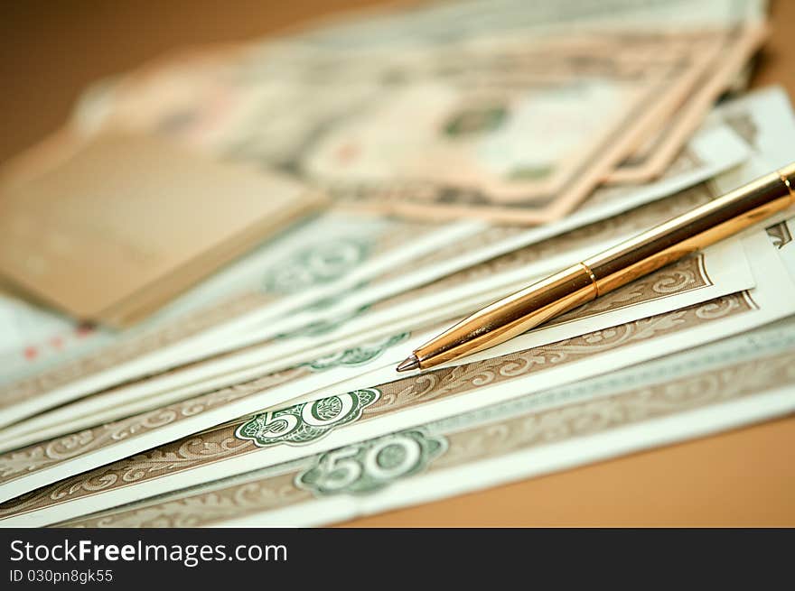 Golden pen, money and bank card. closeup. shallow depth of field. Golden pen, money and bank card. closeup. shallow depth of field.